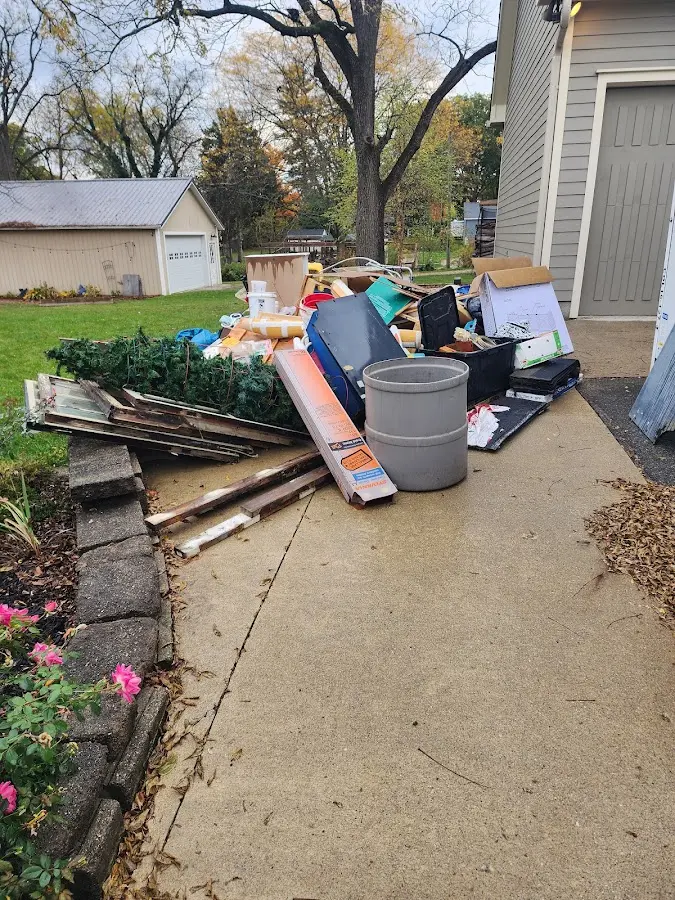 Dumpster being loaded with debris for 12 Yard Dumpster Rental in Baltimore